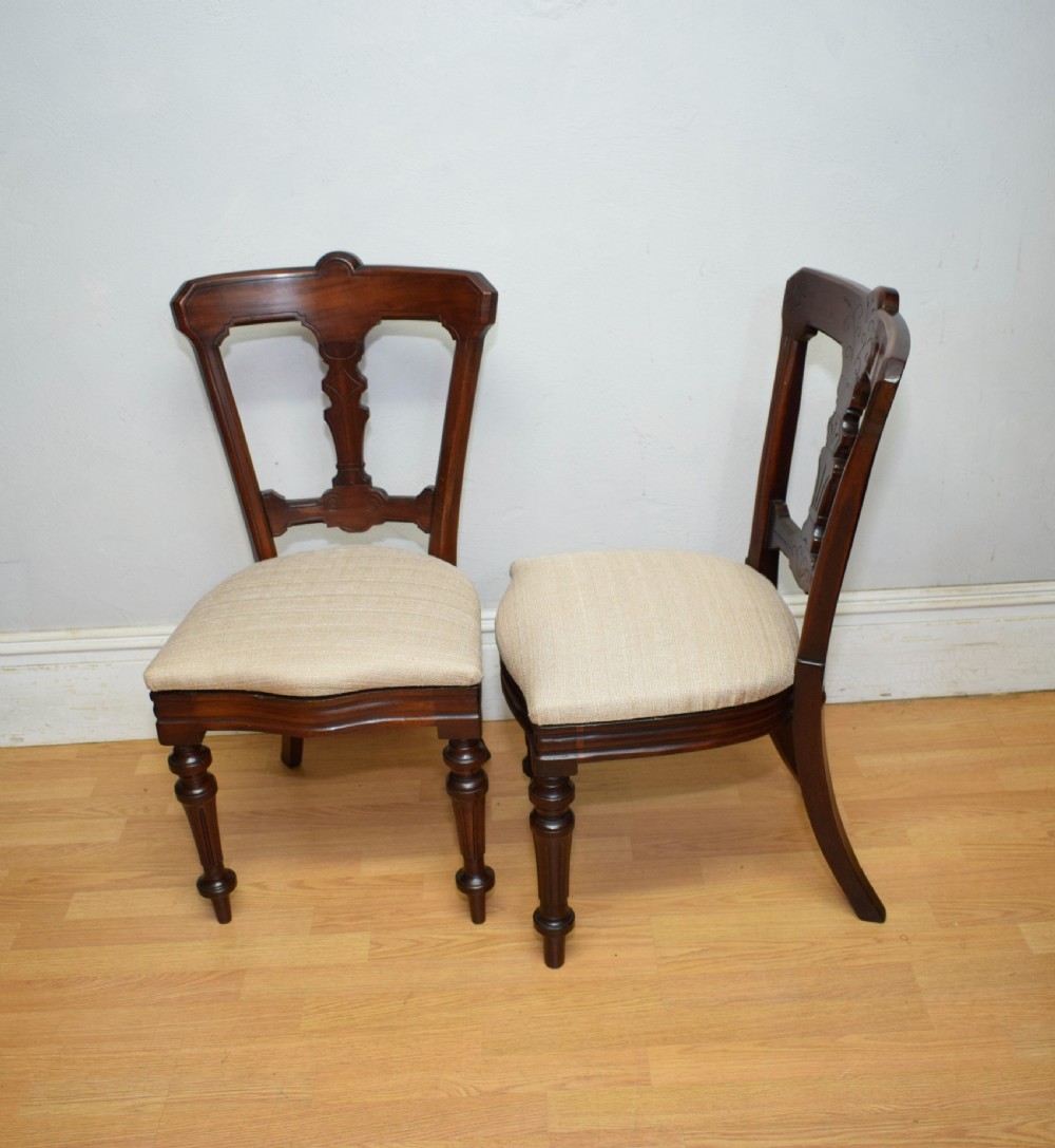 A set of six Victorian mahogany dining chairs featuring carved open backs, turned front legs, and neutral upholstered seats. View XXII