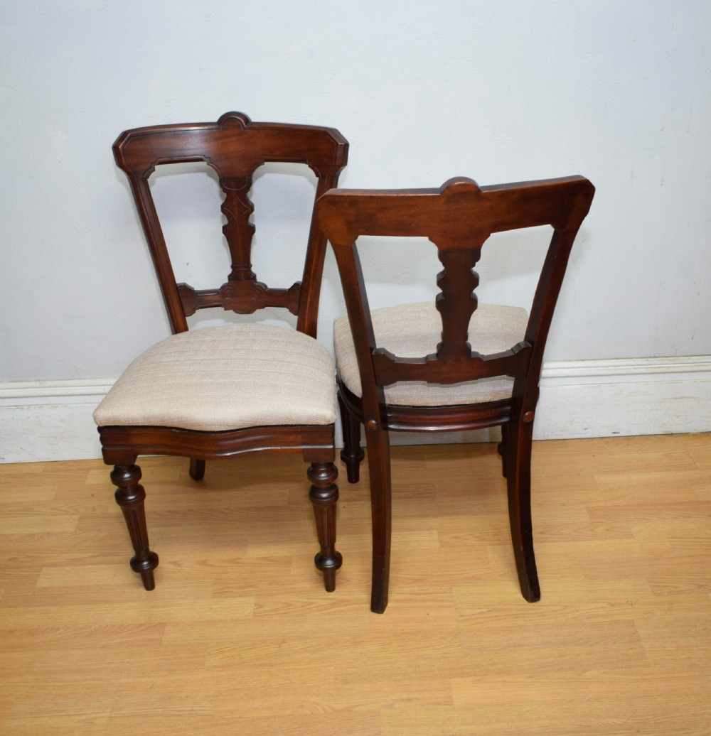 A set of six Victorian mahogany dining chairs featuring carved open backs, turned front legs, and neutral upholstered seats. View XXIII