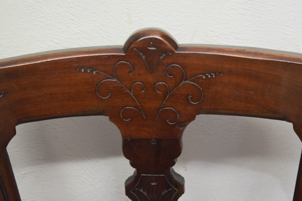 A set of six Victorian mahogany dining chairs featuring carved open backs, turned front legs, and neutral upholstered seats. View XXV