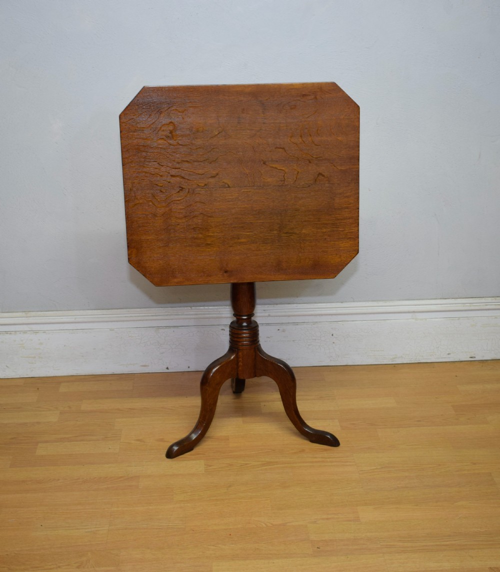 A Georgian oak tripod table with a rectangular top featuring canted corners, a turned pedestal stem, and three downswept legs. View II