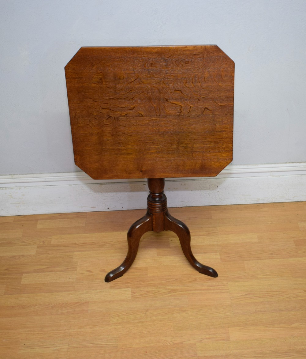 A Georgian oak tripod table with a rectangular top featuring canted corners, a turned pedestal stem, and three downswept legs. View III