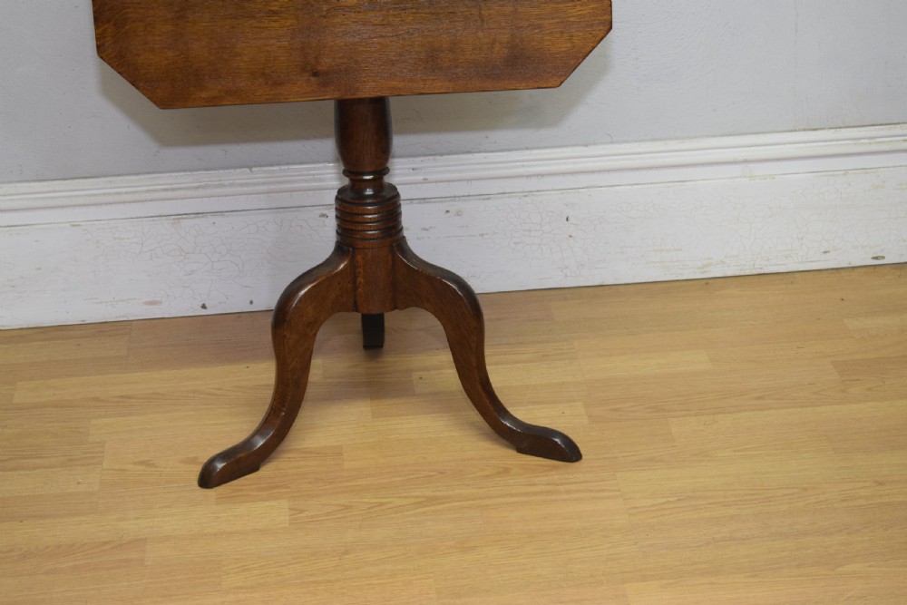 A Georgian oak tripod table with a rectangular top featuring canted corners, a turned pedestal stem, and three downswept legs. View V