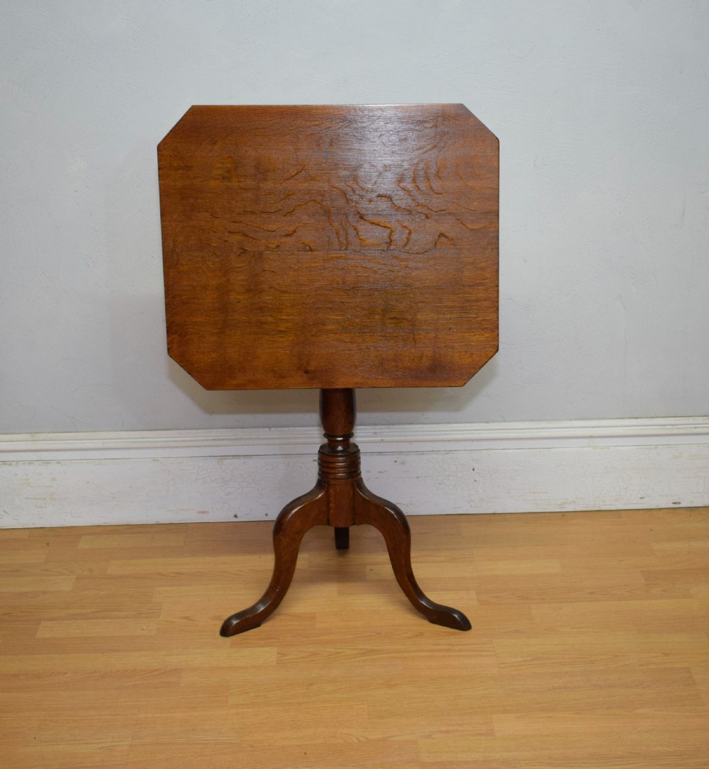 A Georgian oak tripod table with a rectangular top featuring canted corners, a turned pedestal stem, and three downswept legs. View VII