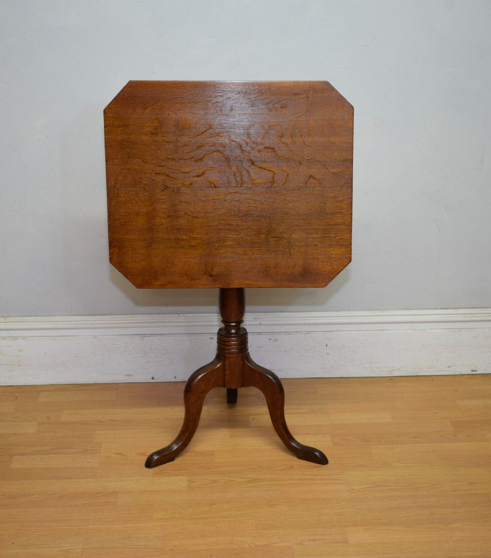 A Georgian oak tripod table with a rectangular top featuring canted corners, a turned pedestal stem, and three downswept legs. View VIII