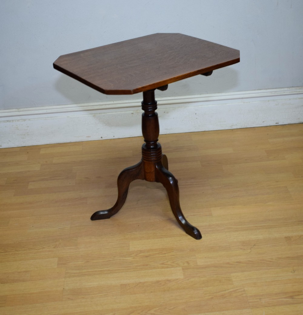 A Georgian oak tripod table with a rectangular top featuring canted corners, a turned pedestal stem, and three downswept legs. View X