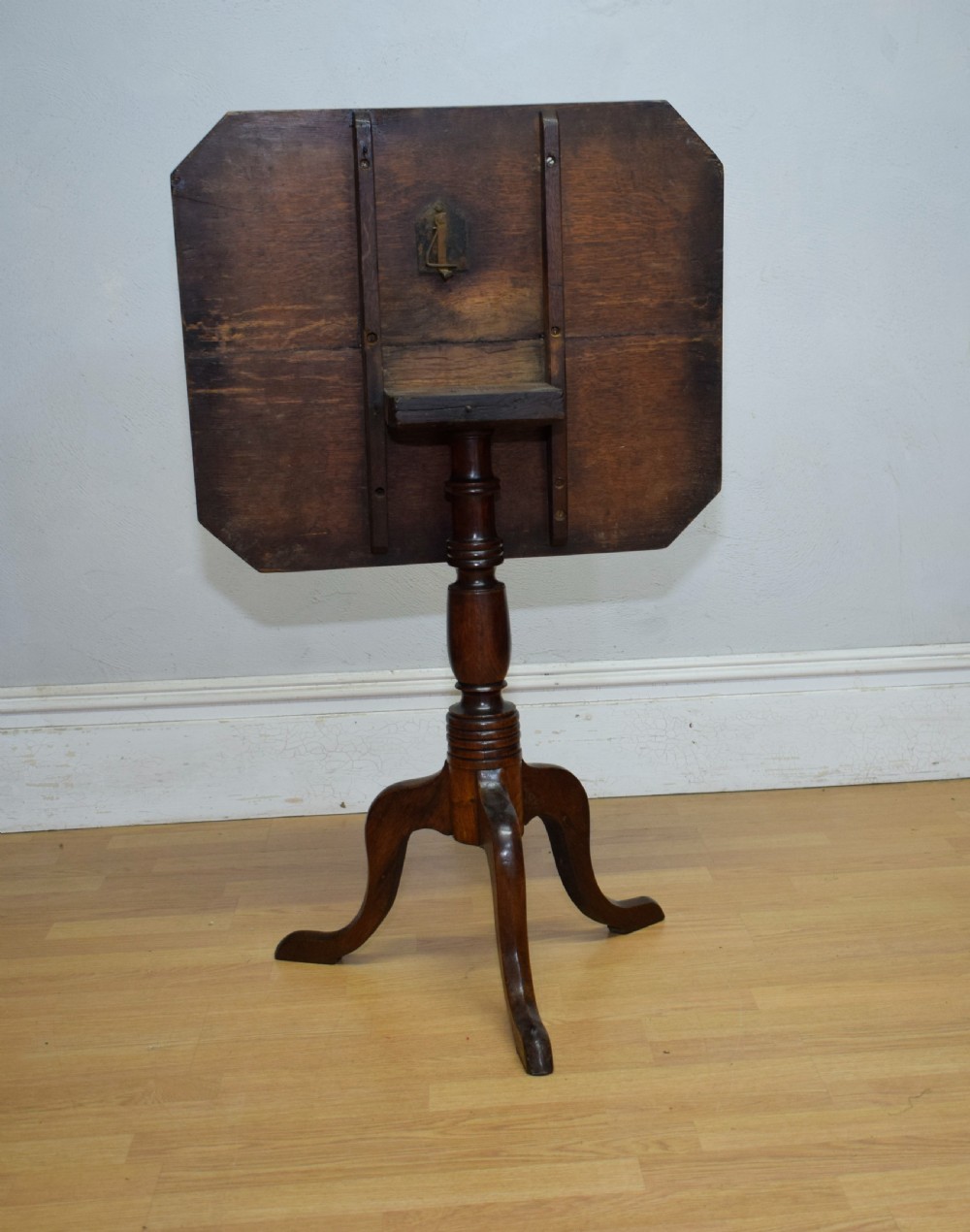 A Georgian oak tripod table with a rectangular top featuring canted corners, a turned pedestal stem, and three downswept legs. View XI