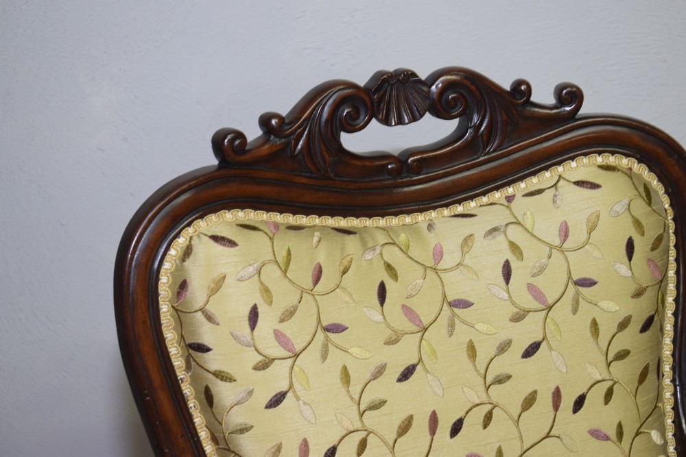 A pair of 19th-century French armchairs featuring carved dark wood frames, cabriole legs with castors, and light green embroidered fabric upholstery. View VIII