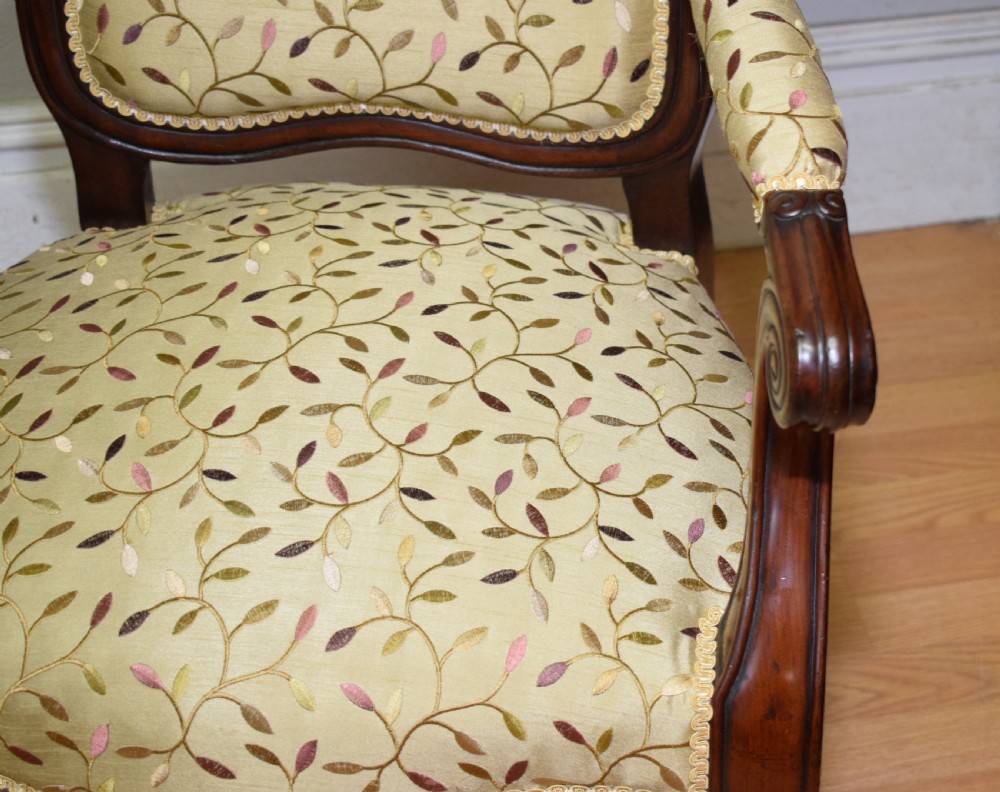 A pair of 19th-century French armchairs featuring carved dark wood frames, cabriole legs with castors, and light green embroidered fabric upholstery. View XI