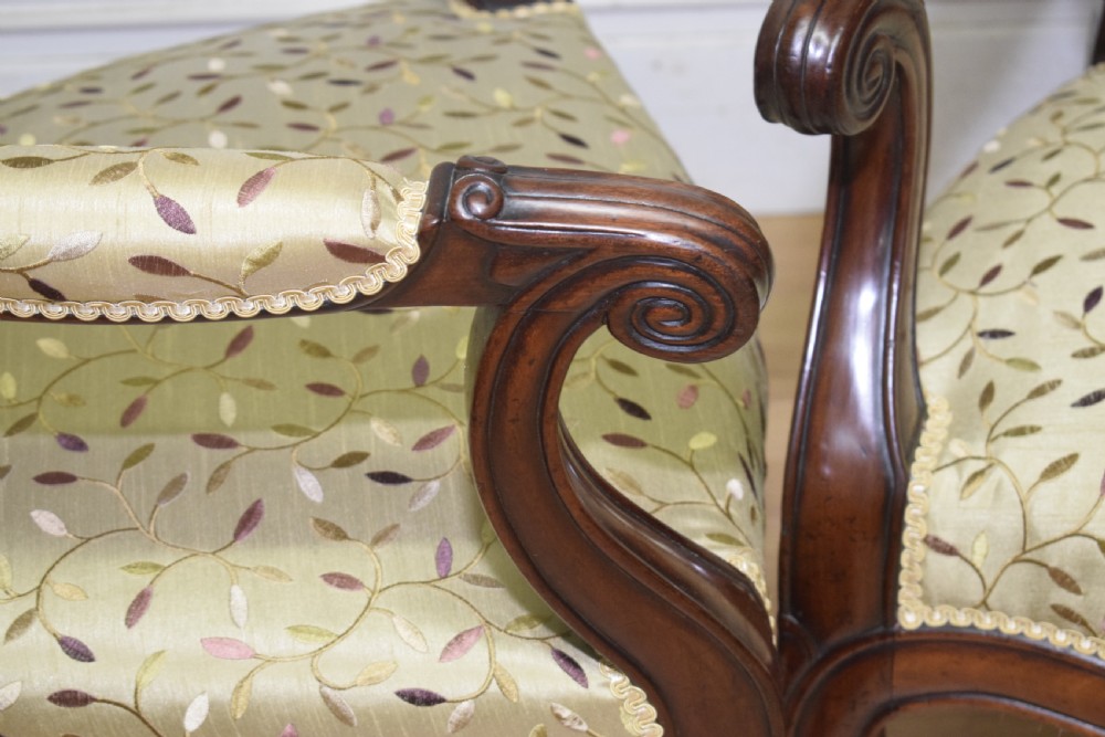 A pair of 19th-century French armchairs featuring carved dark wood frames, cabriole legs with castors, and light green embroidered fabric upholstery. View XIX