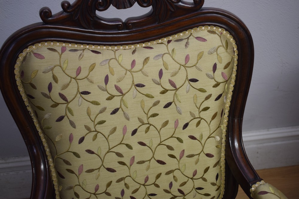 A pair of 19th-century French armchairs featuring carved dark wood frames, cabriole legs with castors, and light green embroidered fabric upholstery. View XXIII