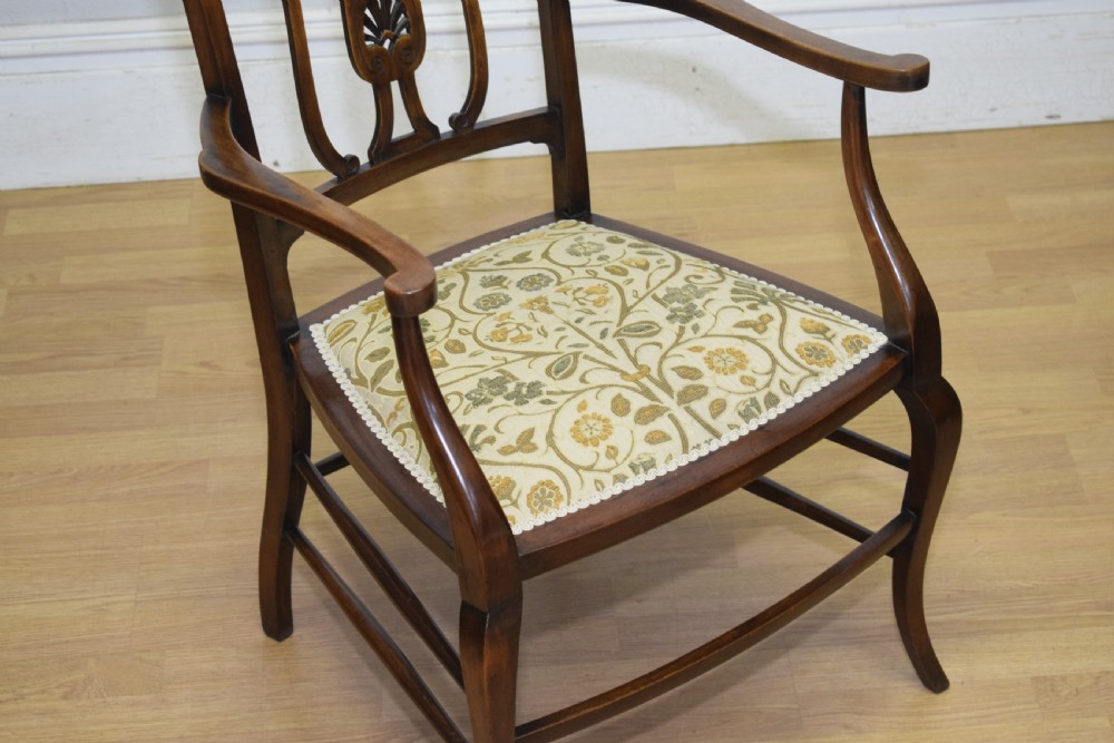 An Edwardian mahogany open armchair featuring a carved splat back, shaped armrests, and floral pattern fabric upholstery. View XIII