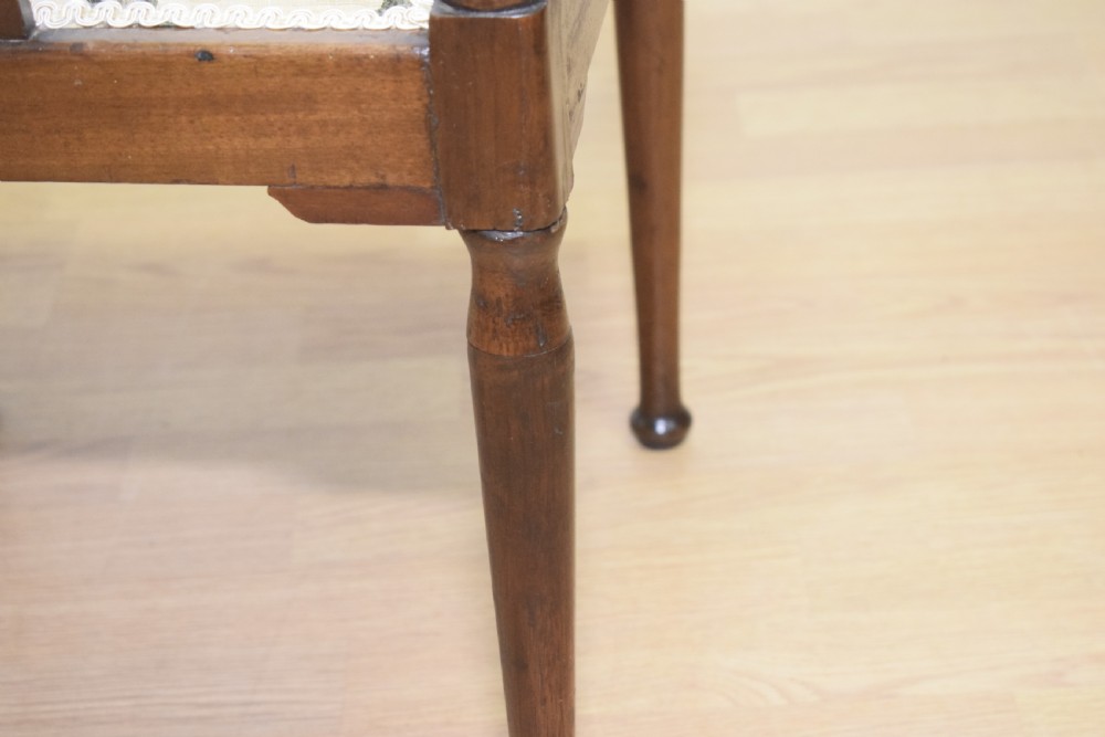 An Edwardian mahogany corner chair featuring a curved top rail with fan inlay, turned spindles, and a floral upholstered square seat. View XIV