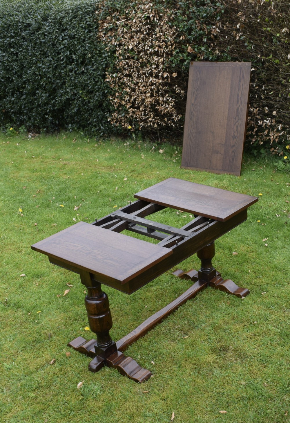 An early 20th-century dark oak refectory dining table featuring turned bulbous legs, a low central stretcher, and a rectangular wooden top. View XXIII