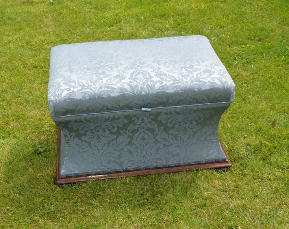 A Regency sarcophagus-shaped ottoman upholstered in blue and silver damask fabric set upon a rosewood plinth base. View III