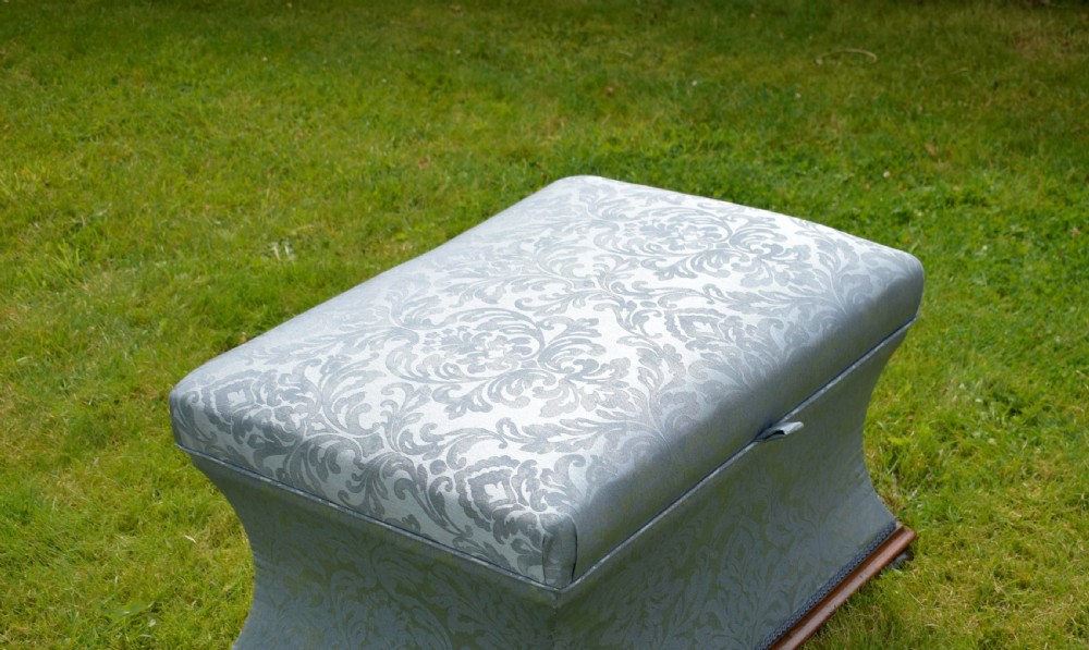 A Regency sarcophagus-shaped ottoman upholstered in blue and silver damask fabric set upon a rosewood plinth base. View VI