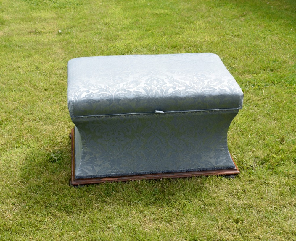 A Regency sarcophagus-shaped ottoman upholstered in blue and silver damask fabric set upon a rosewood plinth base. View VIII