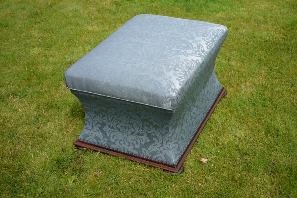 A Regency sarcophagus-shaped ottoman upholstered in blue and silver damask fabric set upon a rosewood plinth base. View IX
