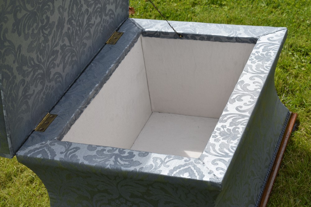 A Regency sarcophagus-shaped ottoman upholstered in blue and silver damask fabric set upon a rosewood plinth base. View XI