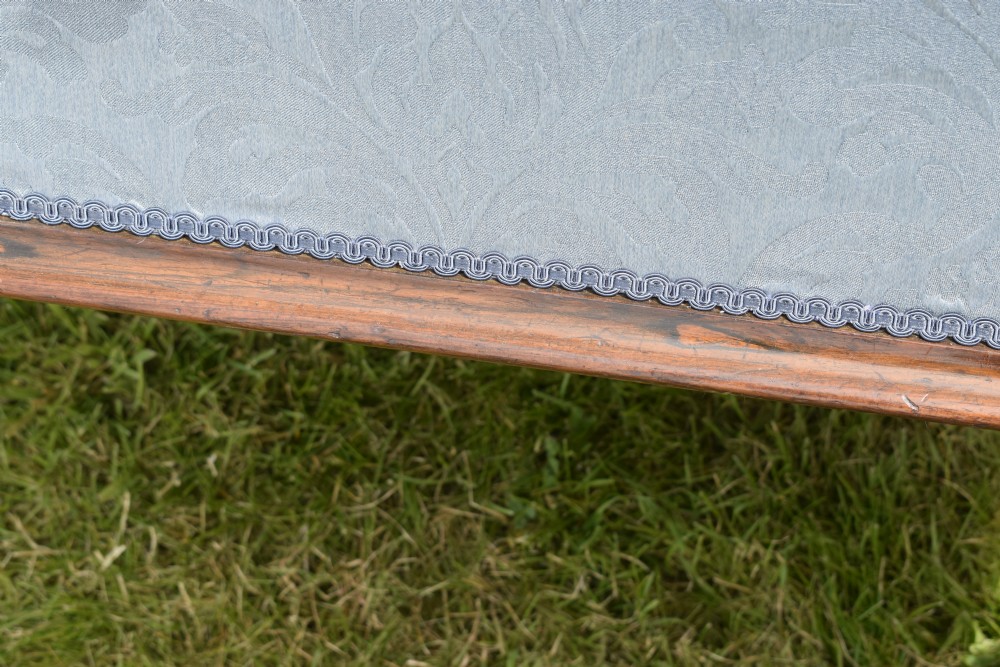 A Regency sarcophagus-shaped ottoman upholstered in blue and silver damask fabric set upon a rosewood plinth base. View XII