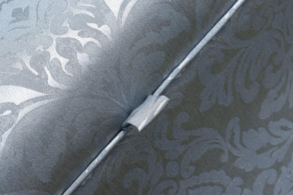 A Regency sarcophagus-shaped ottoman upholstered in blue and silver damask fabric set upon a rosewood plinth base. View XIV