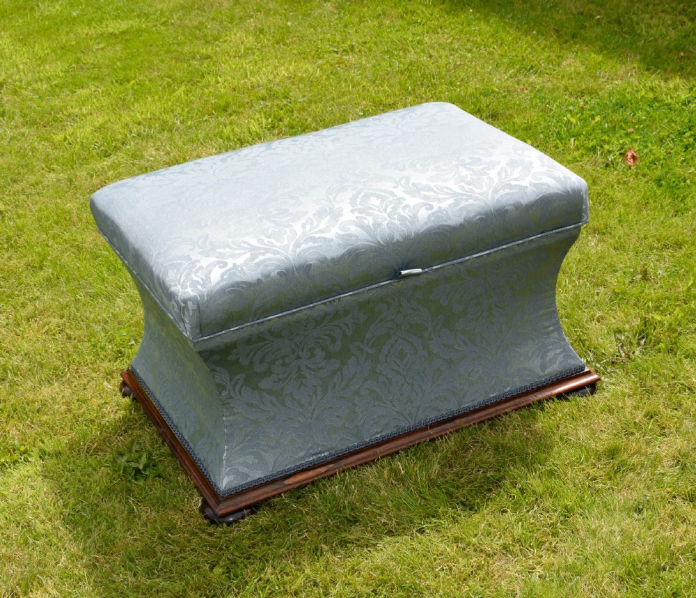 A Regency sarcophagus-shaped ottoman upholstered in blue and silver damask fabric set upon a rosewood plinth base. View XV