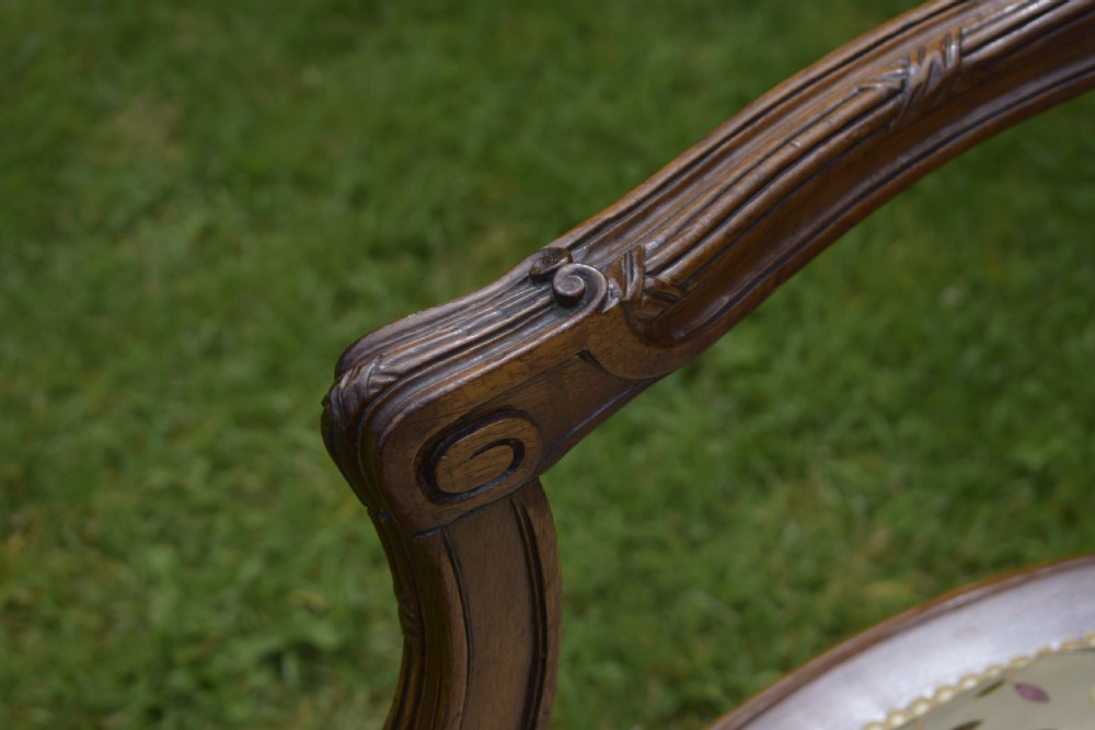 A French carved walnut settee with an oval upholstered backrest, turned fluted legs, and patterned textile upholstery. View VIII