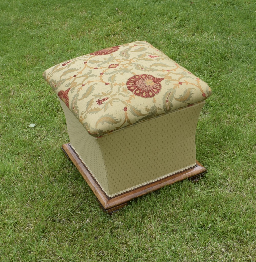 A square William IV upholstered ottoman work box featuring a gold and red floral patterned lid, flared fabric body, and a mahogany plinth base. View VI