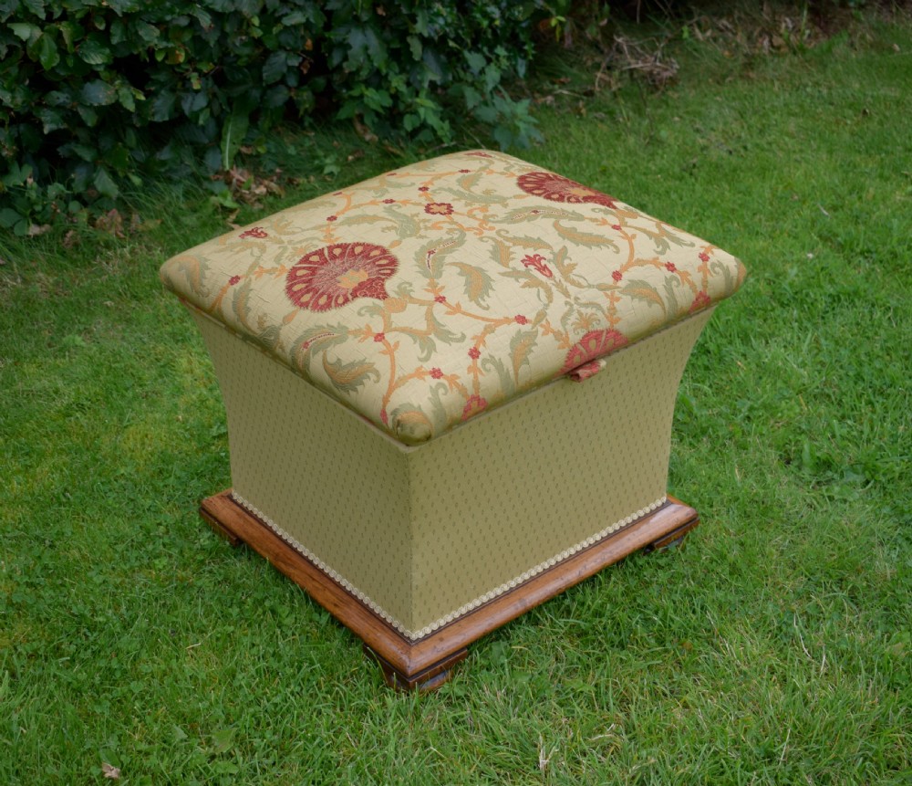 A square William IV upholstered ottoman work box featuring a gold and red floral patterned lid, flared fabric body, and a mahogany plinth base. View IX