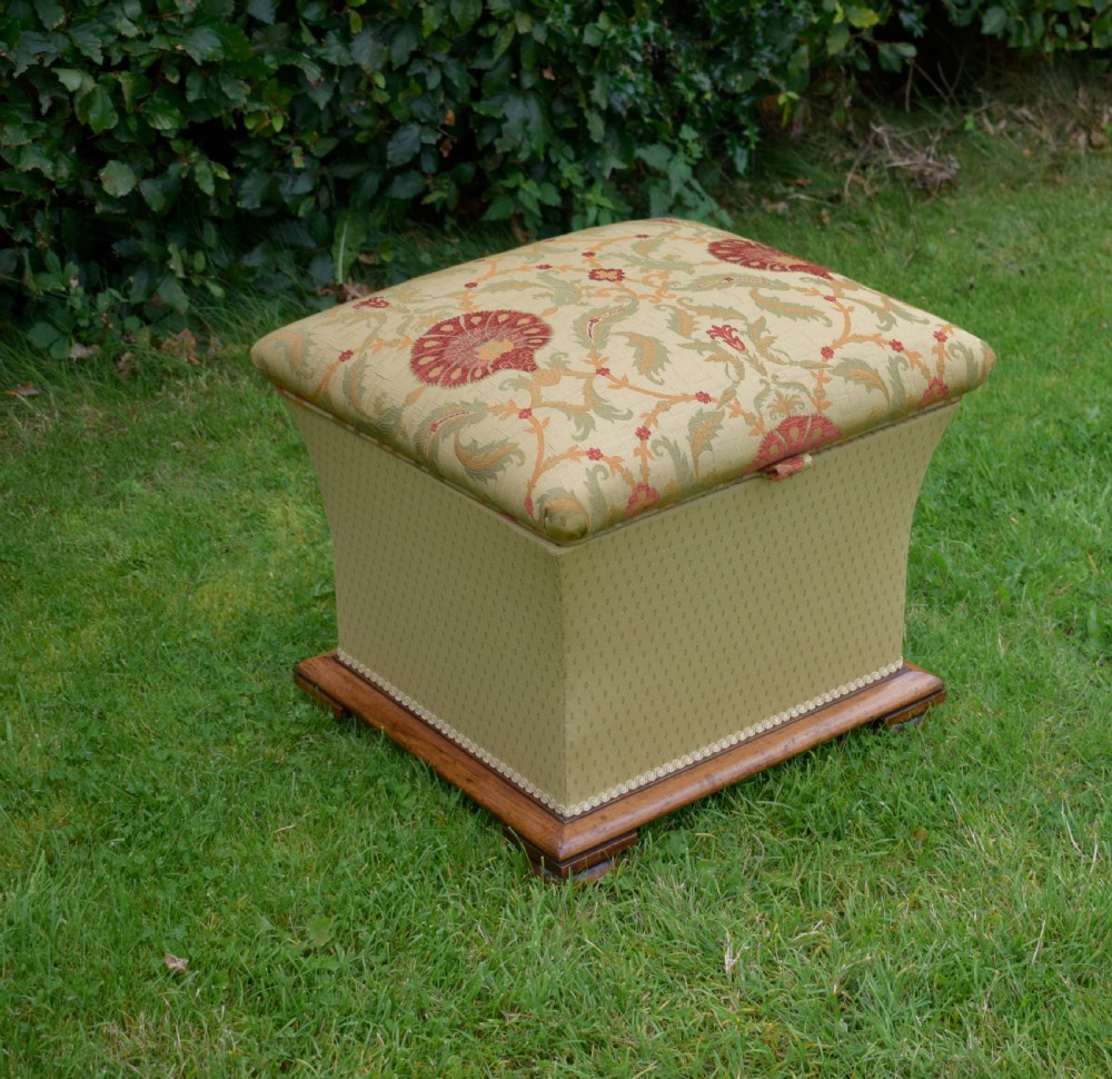 A square William IV upholstered ottoman work box featuring a gold and red floral patterned lid, flared fabric body, and a mahogany plinth base. View XI