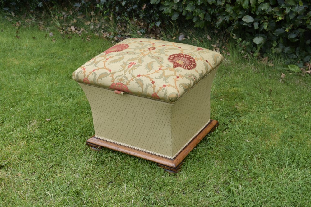 A square William IV upholstered ottoman work box featuring a gold and red floral patterned lid, flared fabric body, and a mahogany plinth base. View XII