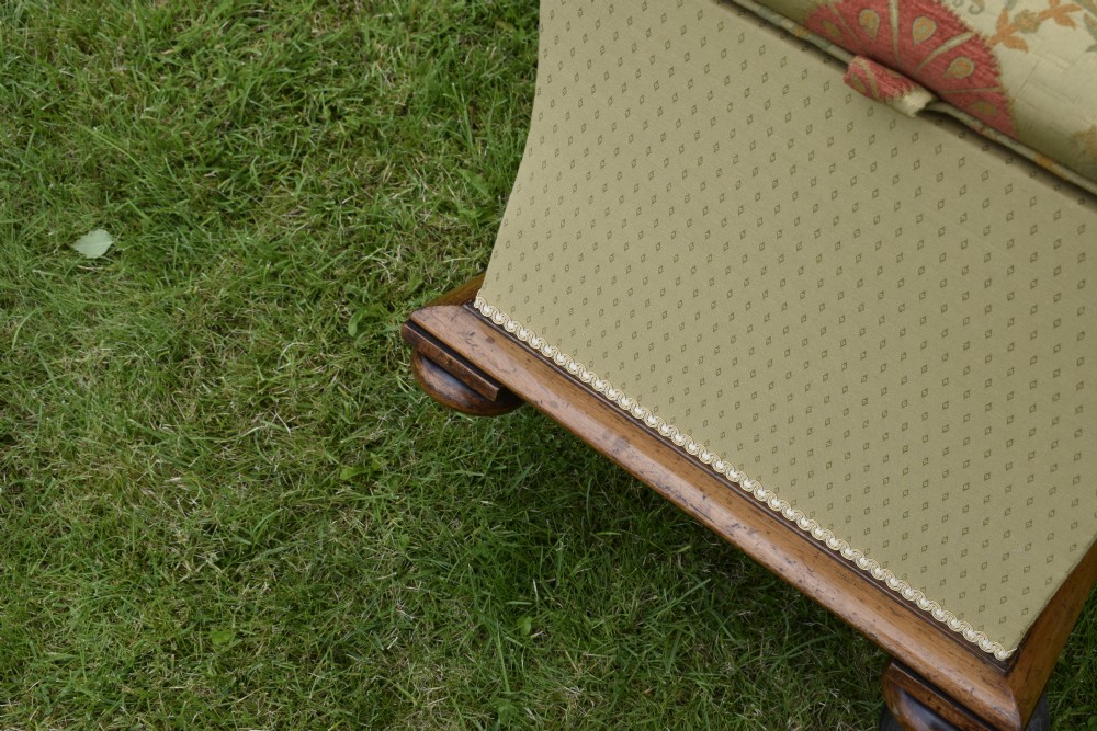 A square William IV upholstered ottoman work box featuring a gold and red floral patterned lid, flared fabric body, and a mahogany plinth base. View XVIII