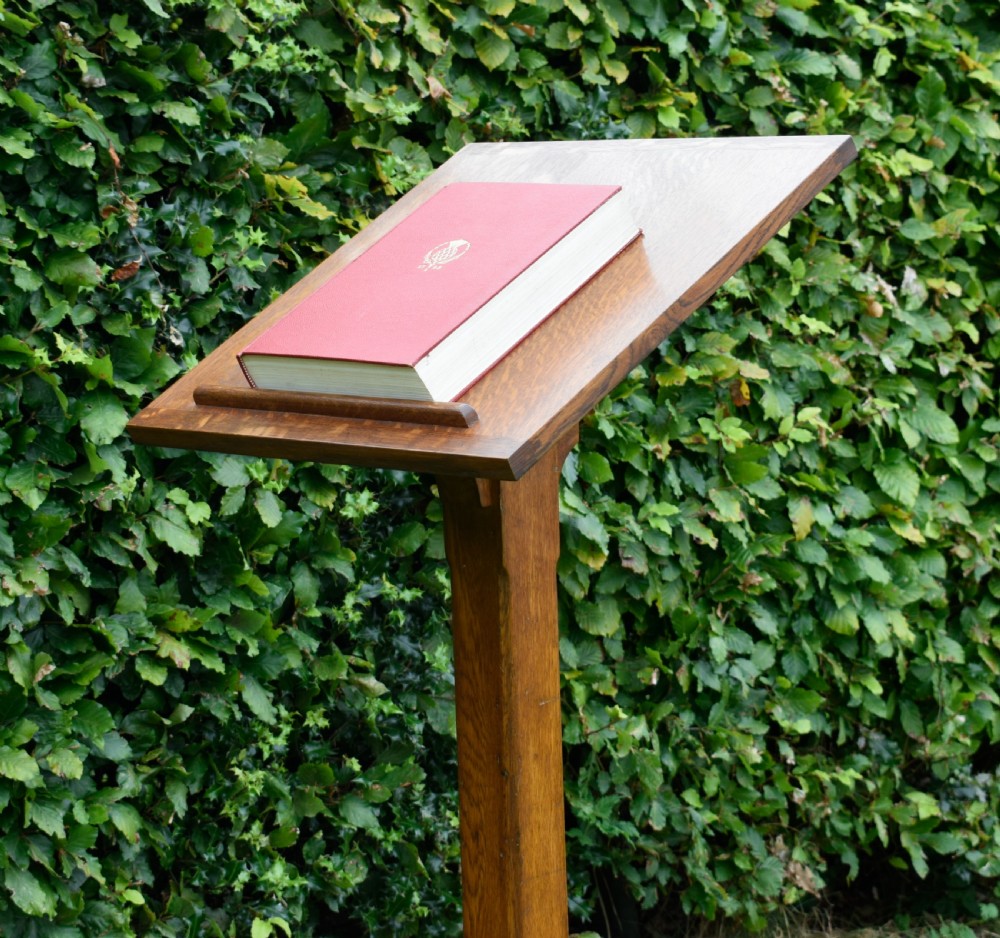 An early 20th-century solid oak floor-standing lectern featuring an angled book rest above a central column supported by a stepped cruciform base. View XVIII
