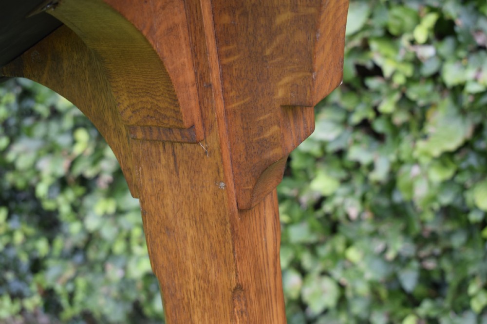 An early 20th-century solid oak floor-standing lectern featuring an angled book rest above a central column supported by a stepped cruciform base. View XXII