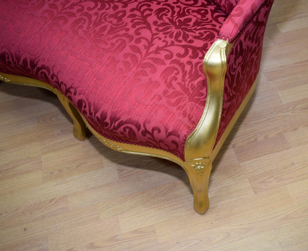 An antique French canape settee with a carved gold-gilded frame, cabriole legs, and red patterned damask upholstery. View XXVI