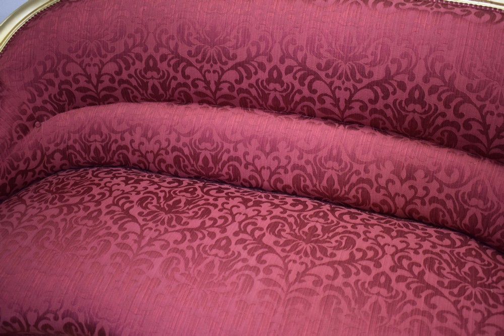 An antique French canape settee with a carved gold-gilded frame, cabriole legs, and red patterned damask upholstery. View XXVII