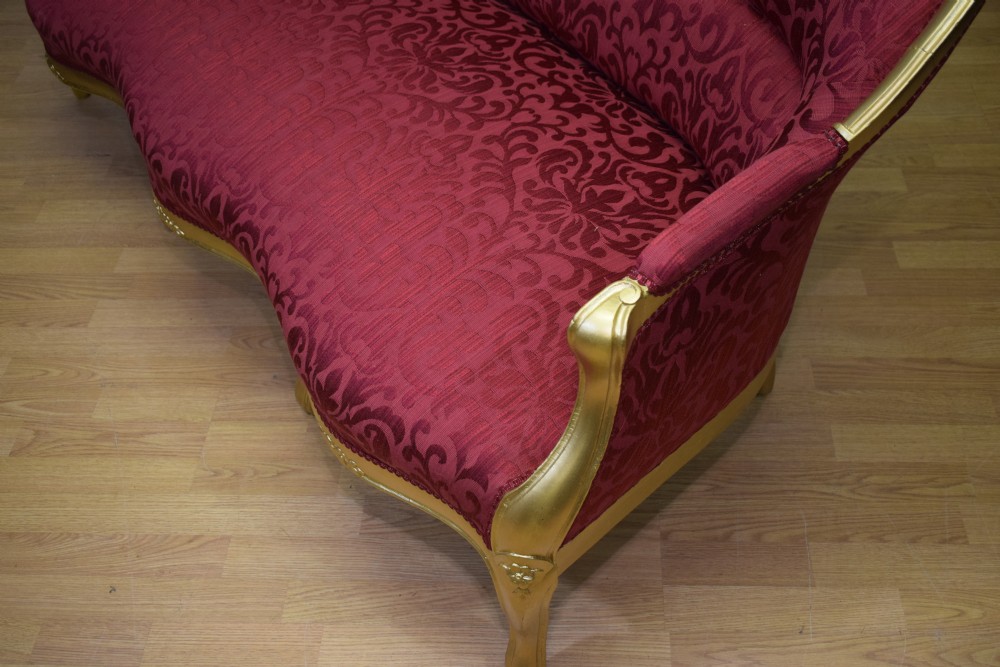 An antique French canape settee with a carved gold-gilded frame, cabriole legs, and red patterned damask upholstery. View XXVIII