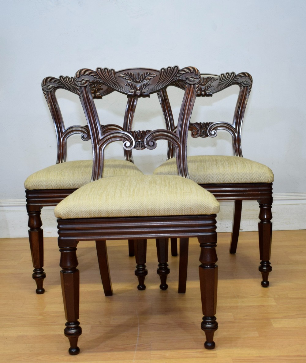 Set of three Scottish Regency mahogany dining chairs featuring carved crest rails, scrolled open backs, turned front legs, and pale green upholstered seats. View VII