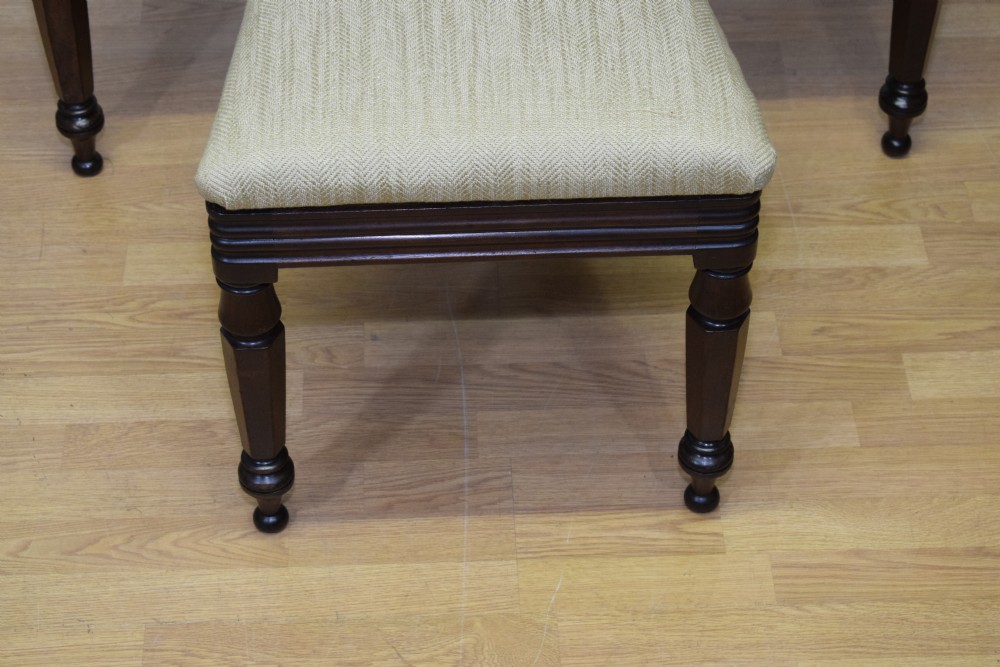 Set of three Scottish Regency mahogany dining chairs featuring carved crest rails, scrolled open backs, turned front legs, and pale green upholstered seats. View VIII
