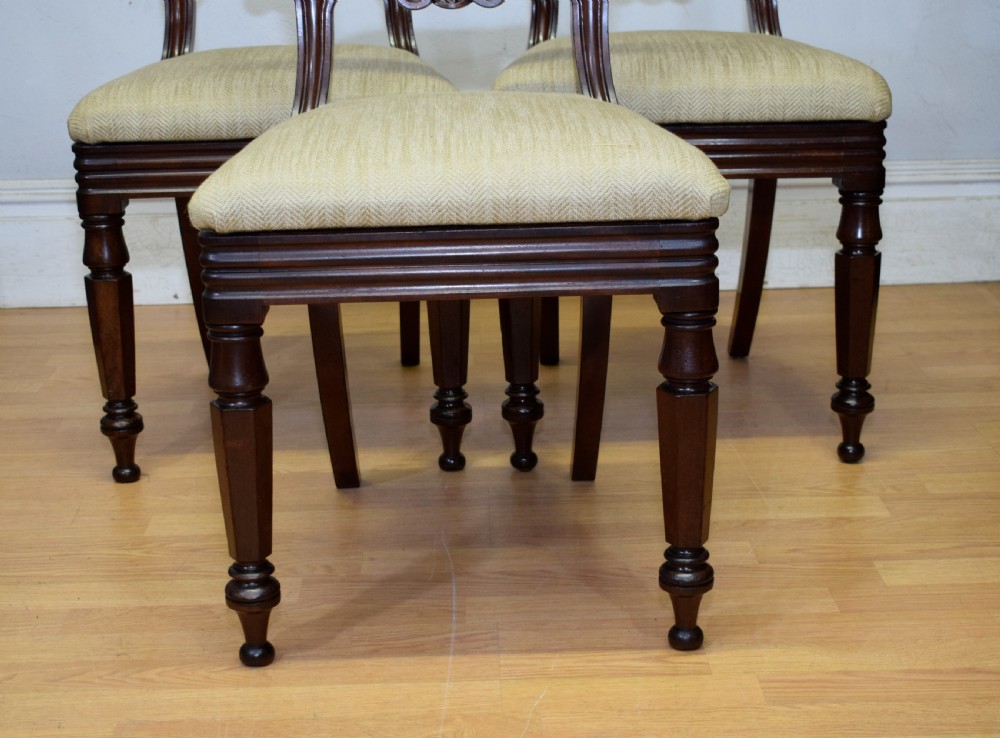 Set of three Scottish Regency mahogany dining chairs featuring carved crest rails, scrolled open backs, turned front legs, and pale green upholstered seats. View IX