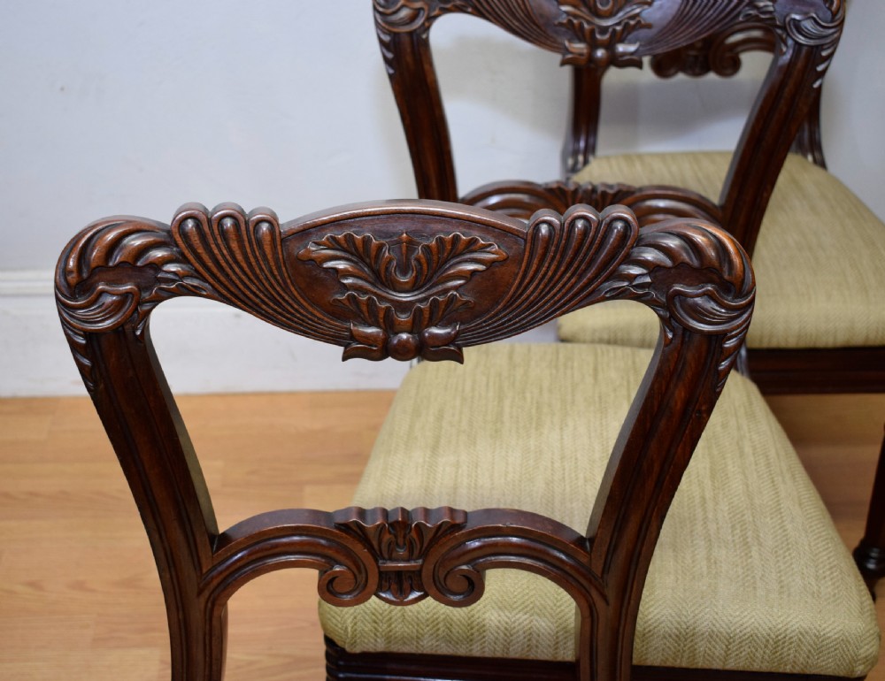 Set of three Scottish Regency mahogany dining chairs featuring carved crest rails, scrolled open backs, turned front legs, and pale green upholstered seats. View X