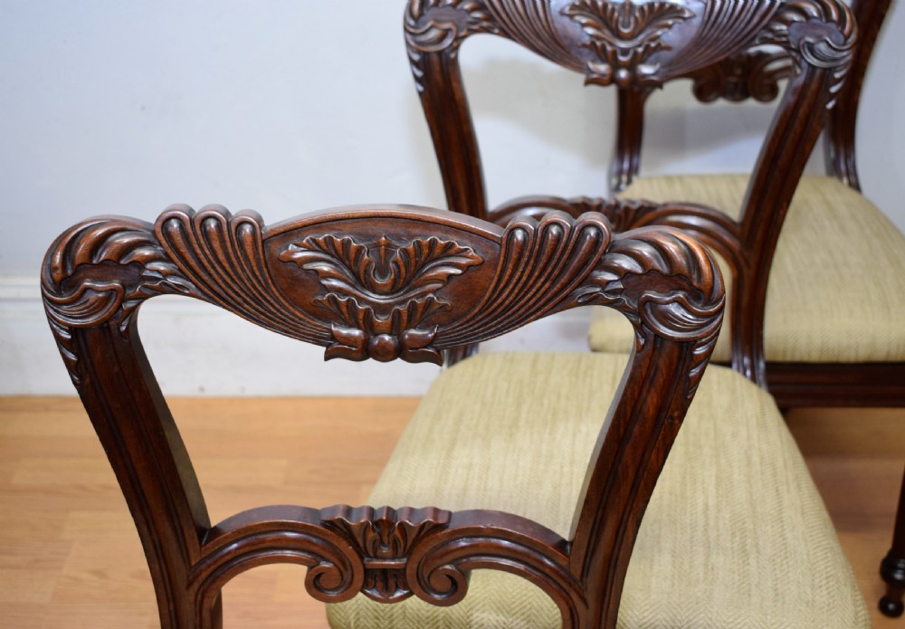 Set of three Scottish Regency mahogany dining chairs featuring carved crest rails, scrolled open backs, turned front legs, and pale green upholstered seats. View XII
