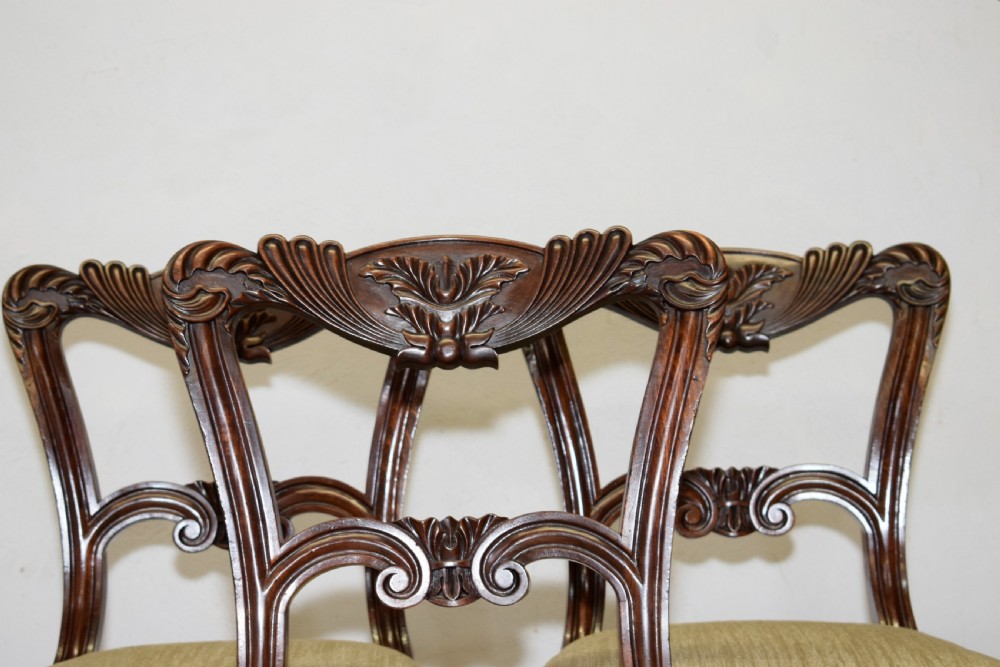 Set of three Scottish Regency mahogany dining chairs featuring carved crest rails, scrolled open backs, turned front legs, and pale green upholstered seats. View XIII