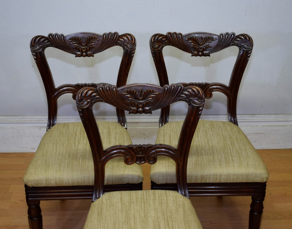 Set of three Scottish Regency mahogany dining chairs featuring carved crest rails, scrolled open backs, turned front legs, and pale green upholstered seats. View XV