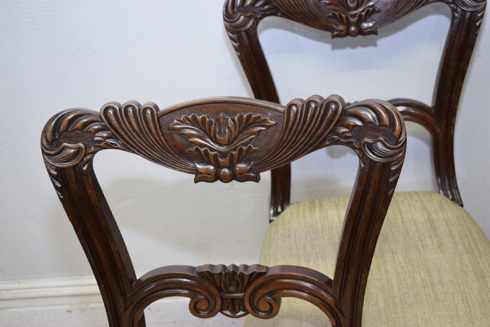 Set of three Scottish Regency mahogany dining chairs featuring carved crest rails, scrolled open backs, turned front legs, and pale green upholstered seats. View XVI