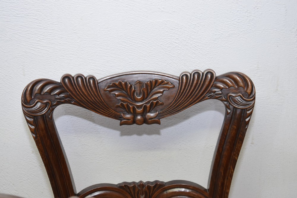 Set of three Scottish Regency mahogany dining chairs featuring carved crest rails, scrolled open backs, turned front legs, and pale green upholstered seats. View XVII