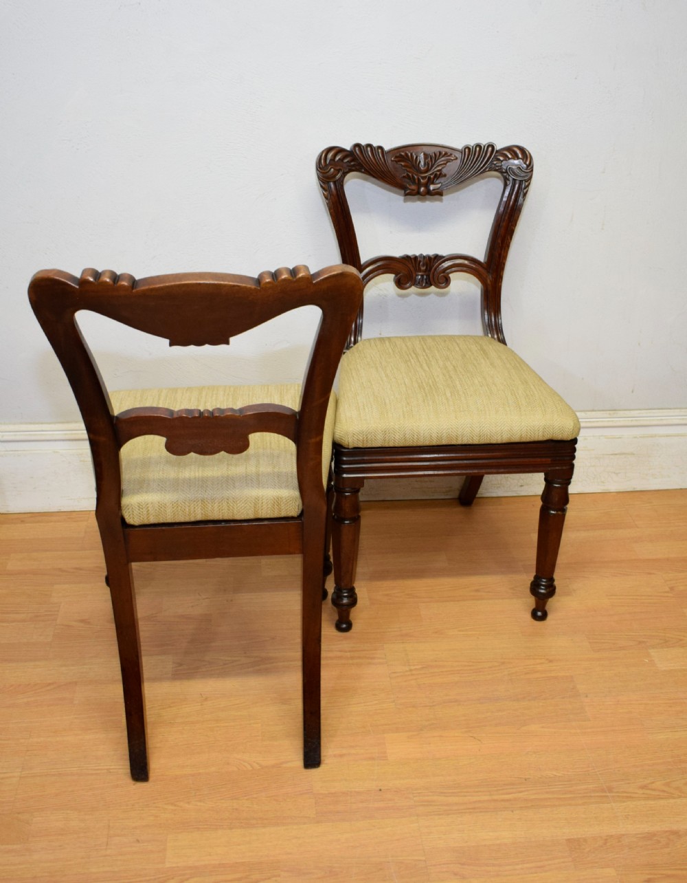 Set of three Scottish Regency mahogany dining chairs featuring carved crest rails, scrolled open backs, turned front legs, and pale green upholstered seats. View XX