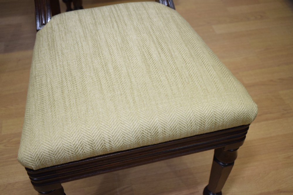 Set of three Scottish Regency mahogany dining chairs featuring carved crest rails, scrolled open backs, turned front legs, and pale green upholstered seats. View XXI