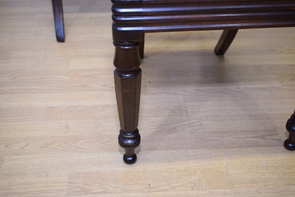 Set of three Scottish Regency mahogany dining chairs featuring carved crest rails, scrolled open backs, turned front legs, and pale green upholstered seats. View XXII