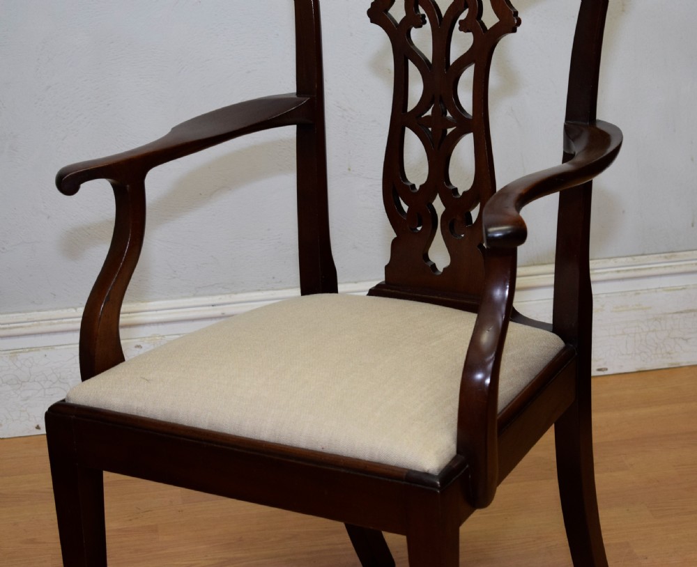 A 19th-century mahogany open armchair featuring a carved pierced back splat, curved arms, and a neutral cream upholstered seat. View VII