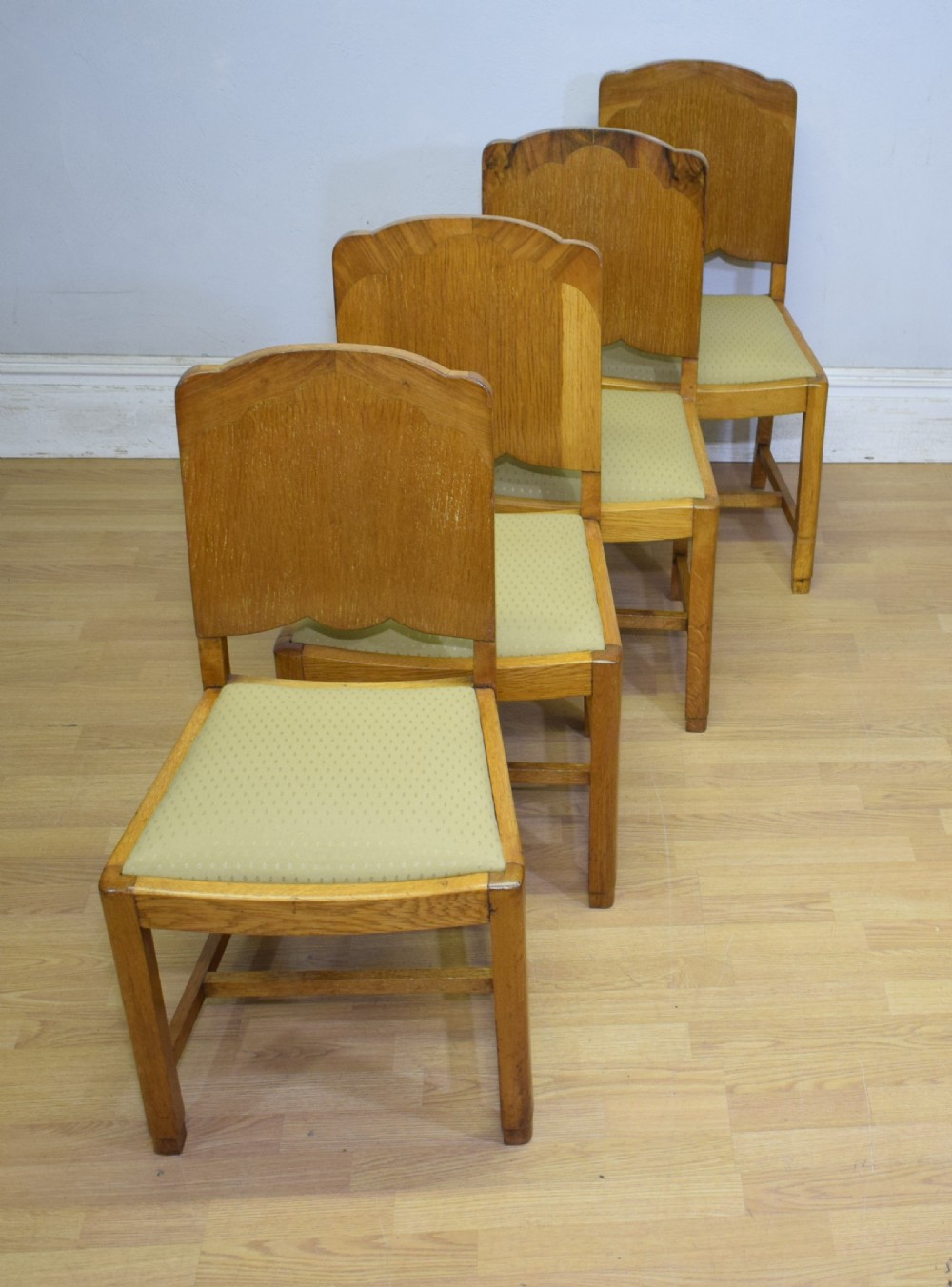 An Art Deco light oak dining suite featuring a shaped table with a central pedestal surrounded by four matching upholstered chairs. View IX